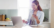 © peopleimages.com - Creative woman, laptop and credit card for online shopping, ecommerce and purchase in kitchen. Lady, computer and payment for internet subscription, review and retail with technology and customer