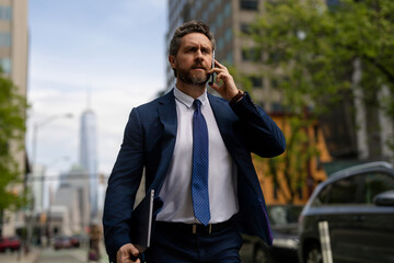 Wall Mural - Businessman with phone run in NY. Business talk. Businessman run down street talking on the phone. Man in suit late. Business call. Running business man. Fast business. Run and late businessman.