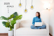 © freebird7977 - 2025 goals with young woman pointing goals cheerful and happy new year with laptop on the sofa in living room.  Star together new year 2025