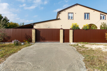 Wall Mural - A house with a brown fence and a white door