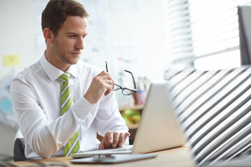 Poster - Reading, glasses and business man on laptop in office for website search, online project and b2b email. Professional, corporate and person on computer for planning, research proposal and internet