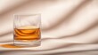 © Kittipong - Glass of Whiskey on Beige Fabric Background