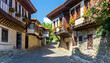 Historical houses built with wooden and stone architecture in Turkey. Tourism geography texture with bay window structure, narrow streets, stone pavements, engraved windows and ivy flowers.