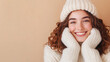 © Alla Bondaruk - Happy woman wearing a cozy white winter sweater, gloves, and hat, posing cheerfully against a beige background in a winter setting mockup, mock up, template, empty, for text, place, copy space