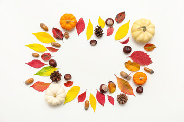 Wall Mural - Heart made of autumn leaves, acorns, chestnuts, pine cones and fresh pumpkins on white background