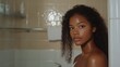 © VK Studio - A woman with glistening skin stands in a steamy bathroom, embodying beauty and freshness in everyday moments.