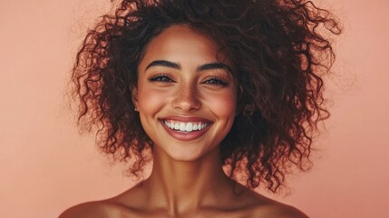 Wall Mural - Happy African Beauty Model with Afro Hairstyle. Cheerful smiling Woman with Dark Skin and Black Coily Hair over Beige. Face and Body Care