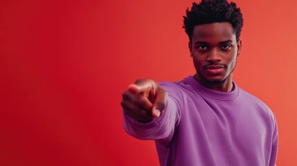 Poster - A person wearing a purple shirt points at the camera with intent, suitable for various uses such as illustration or storytelling