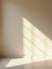 Poster - Soft sunlight fills an empty room creating a calm ambiance as subtle shadows dance across a textured taupe wall and minimalistic design unfolds