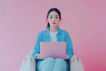 Poster - a woman sits in a chair with a laptop, focused on her work