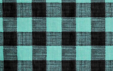 Poster - Turquoise and black checkered fabric texture background, ideal for design.