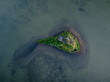 © Kleger photography - Small island in shallow waters with densely lush green vegetation