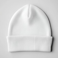 A simple white beanie hat displayed on a neutral background for winter fashion and warmth