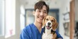© Adobe Contributor - Asian veterinarian smiling with a beagle