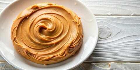 Poster - A single serving of peanut butter spread on a white plate, a simple yet satisfying snack