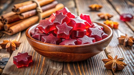 Poster - Star-Shaped Red Candies in a Wooden Bowl with Cinnamon Sticks and Star Anise on a Rustic Wooden Background