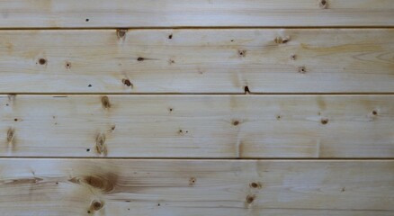 Wall Mural - plank background of light knotty wood, wide planed boards as a texture of a wooden surface with empty copy space