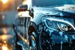 © Yuliia - Modern car during washing process with foam and water droplets creates premium automotive detailing and maintenance service concept.