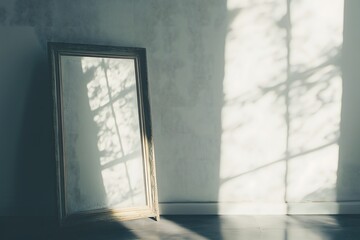 Wall Mural - Sunlight shining in on a mirror standing up against a white wall 