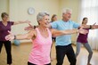 ©  S u n n y B u n n y - Active seniors engaging in group exercise class for health and wellness.