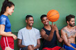 © peopleimages.com - Team, basketball and happy people spinning ball at court for match, fitness exercise and wellness. Sports, athletes or group of healthy players with smile for performance, workout or outdoor game