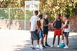 © peopleimages.com - Basketball, group and men outdoor on sport court with friends, discussion and exercise break. Fitness, team and diversity with workout and training for game with teamwork together and conversation