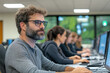 © sharafmaksumov - Diverse Team Of Customer Service Reps Collaborating In An Open Office Space, With Computers And Communication Tools, Emphasizing Teamwork And Support