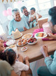 © peopleimages.com - Big family, senior people and dessert with party, cake and love for home birthday celebration. Mature man, woman and grandparents with children, support and event for retirement and holiday bonding