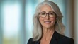 © BrandwayArt - Elegant senior businesswoman presents ideas in a modern office