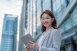 © artemstepanov - Asian business woman leader entrepreneur, smiling young professional manager holding digital tablet