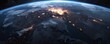 © Дмитрий Бабенко - A stunning view of Europe illuminated at night from space highlighting major cities and geographical features against the darkness of Earth
