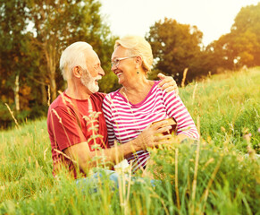 Wall Mural - woman man outdoor senior couple happy lifestyle retirement together smiling love reading nature book