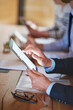 © peopleimages.com - Meeting, tablet and hands of businessman closeup with team in workshop for finance, notes and agenda. Digital technology, conference room and manager research, scroll screen and minutes in office