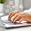 © VIK - The person typing on a laptop has star icons as feedback or ratings.