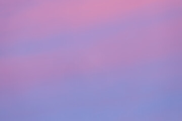 Wall Mural - A beautiful sky tinted by the sun leaving vibrant shades of gold, pink, blue and multicolored. Clouds in the twilight evening and morning sky. Cloudy sky background in the evening, and during the day.