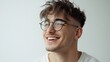 © WS Studio 1985 - Smiling Young Man with Trendy Haircut and Glasses, Radiating Confidence and Style, Against a Soft White Background for Modern Lifestyle Imagery