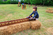 © dargog - Child playing outdoor ring toss game in park. Recreation and summer fun concepts.