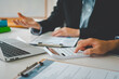 © photobyphotoboy - close up The business person is sitting on a calculator with a graph in the office of finance accounting concept