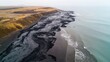 © Robin - Aerial view of coastal area with dark, sticky tar covering beach and seawater, highlighting environmental pollution and providing copy space for text or design.