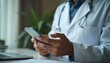 © Tahubulat - A doctor using mobile phone while sitting at her working place