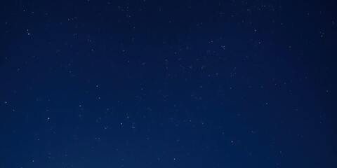 Wall Mural - a serene night sky with a scattering of stars against a dark blue background, space, astronomy, univ