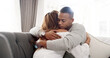 © peopleimages.com - Hug, house and black couple on sofa, love and compassion with sympathy in living room. African people, man and woman on couch, embrace and relationship with marriage, comfort and grief with empathy