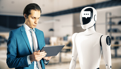 Poster - Businessman interacting with a humanoid robot in an office environment, focusing on a tablet. Concept of AI in workplace communication.