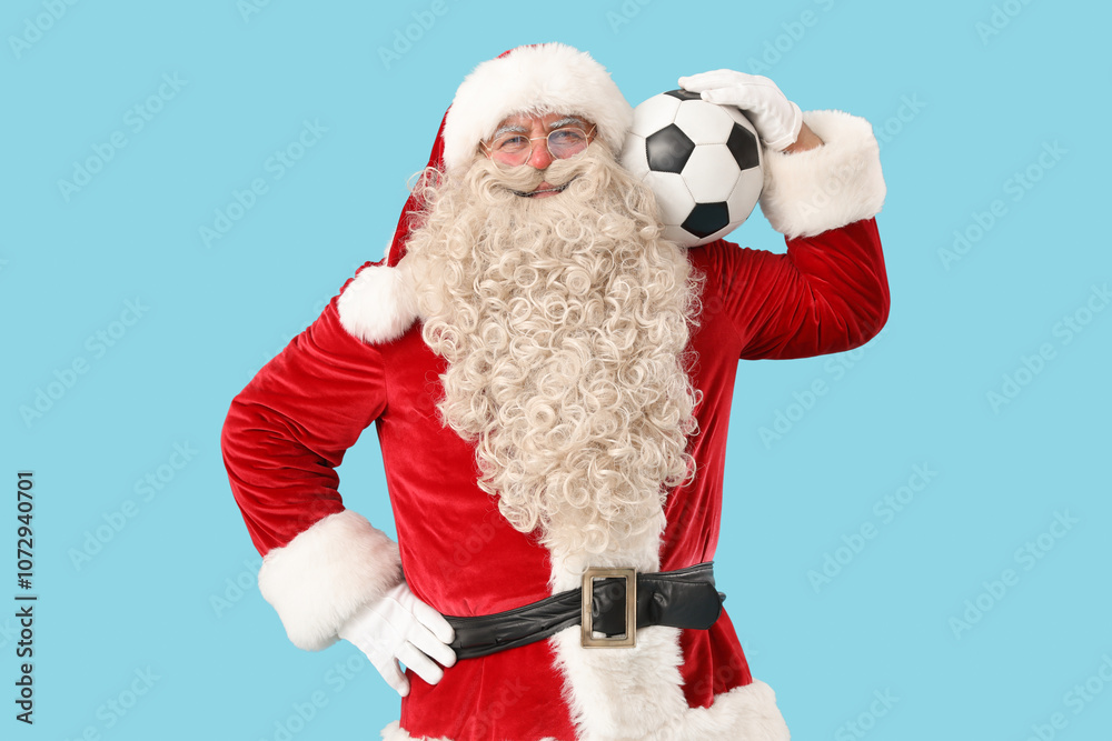 Santa Claus with soccer ball on blue background
