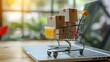 © creative - Product package boxes and shopping bag in cart with laptop computer which web store shop on screen for online shopping and delivery concept with miniature shopping cart standing in front of laptop