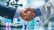 © Antonster - Doctor and medical researcher shake hands in laboratory setting with scientific equipment present