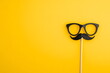 © imam - Black Paper Mustaches and Glasses on a yellow Background, AI generated
