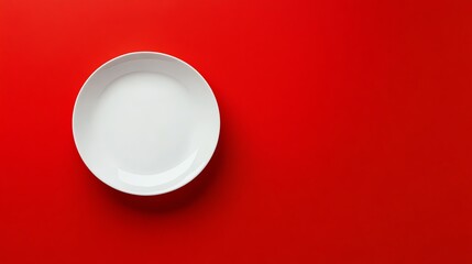 An empty white plate on a red background.