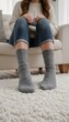 © ElseThen - Cozy autumn afternoon at home with warm, slouchy grey socks and a knitted sweater on a soft rug