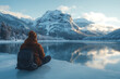 © Evhen Pylypchuk - Person ice fishing on a frozen lake, dressed in warm winter clothing, surrounded by a serene snowy landscape, capturing the calm and peaceful atmosphere of winter outdoor activities.